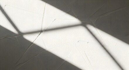 Sunlight casting geometric shadows on a textured white wall, creating a minimalist and modern background.