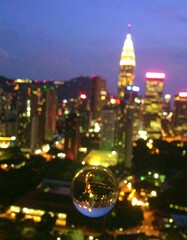 City lights reflected in a crystal sphere