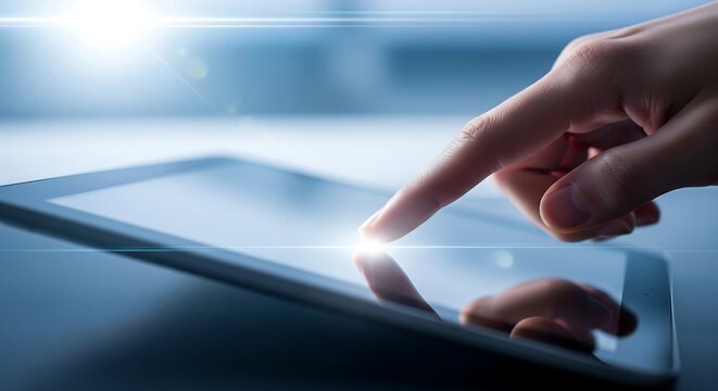 A hand interacts with a tablet's touch screen, highlighting modern technology and digital interaction.