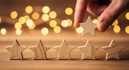 Hand placing a wooden star to complete a five-star rating on a wooden surface with blurred lights in the background.