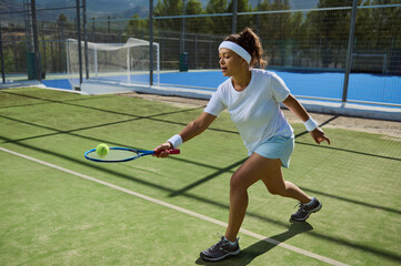 Young Female Tennis Player Practicing on Outdoor Court with Intensity and Focus