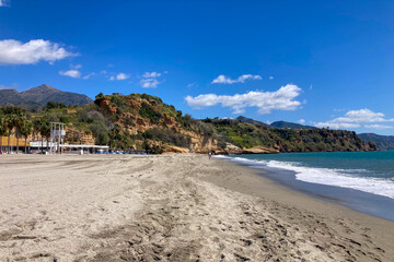 Wonderful landscapes of the shimmering sea and charming city unfold, offering breathtaking coastal views and a picturesque atmosphere in Nerja, Spain