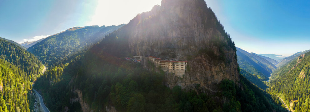 Panoramic aerial view of the historic Sumela Monastery on a steep cliff in Trabzon, Turkey. Ancient Greek Orthodox monastery surrounded by misty mountains and green forests in Black Sea region.