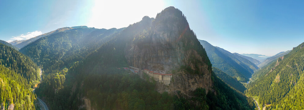 Aerial panoramic view of the historic Sumela Monastery on a steep cliff in Macka, Trabzon, Turkey. Ancient Greek Orthodox monastery surrounded by misty mountains and green forests in Black Sea.