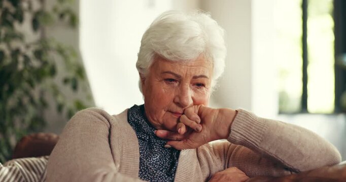 Stress, thinking and senior woman in home with regret, mistake and remember memory. Sad, depression and elderly person in living room with reflection, loneliness and worry in retirement house