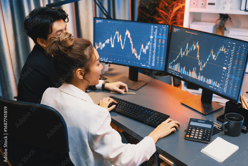 Poster smiling asian business traders pointing to dynamic stock exchange data screen profit value online we