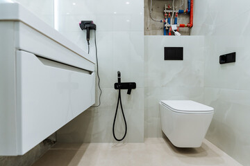 Explore a modern bathroom featuring a sleek toilet and stylish fixtures that focus on hygiene,...