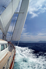 Luxury sailing yacht navigating waves in Phuket's regatta for ultimate relaxation and adventure