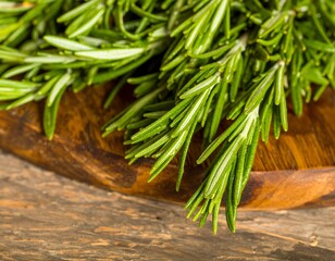 Fresh rosemary sprigs on a wooden board (1)