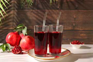 Pomegranate juice drink and ingredients, rich pomegranate drink on elegant sunny table, detox diet and weight loss concept, natural food for healthy lifestyle, source of vitamin C