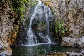 Waterfall cascading into rocky basin