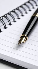 Naklejka premium Pen resting on spiral-bound notebook