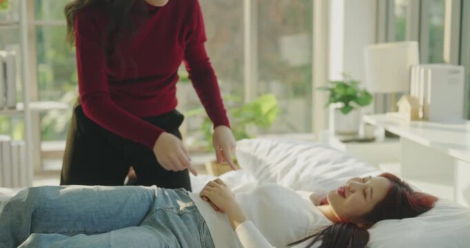 Roommate concept of 4k Resolution. Asian women teasing each other on the bed in the bedroom.