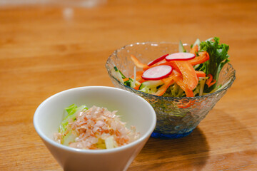 Japanese appetizer with fresh vegetable salad and small side dish
