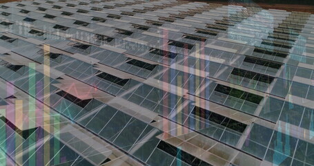 Tilted photovoltaic panels reflecting surroundings on outdoor solar array, with bar-chart overlays