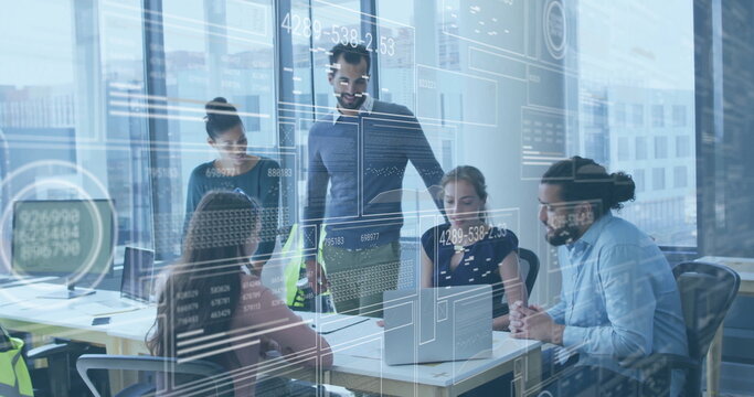 Discussing group of developers examining laptops in office with glass partitions and code overlays