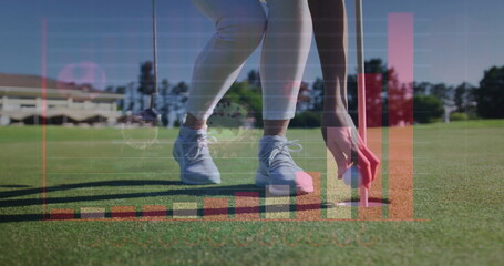 Bending golfer in athletic pants placing golf ball into hole on putting green, with data overlays