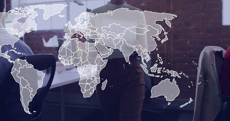 Presenting professional woman holding tablet in office meeting, with world map graphic, jacket