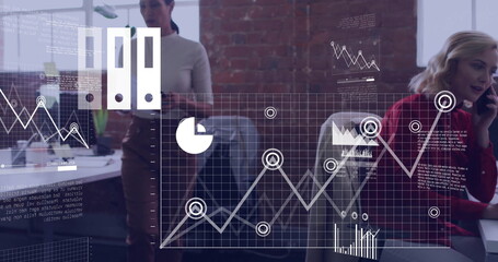 Analyzing holographic overlay, four professionals working in modern office with computer monitors