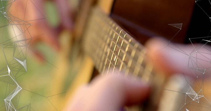 Pressing musician's fingers playing chords on acoustic guitar fretboard in yard, with overlay
