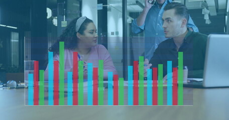 Professionals in business attire discussing data trends in office meeting, with notebook smartphone