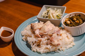 Steamed chicken rice dinner with side dishes
