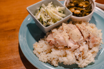 Steamed chicken rice dinner with side dishes

