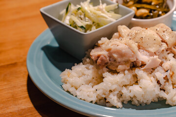 Steamed chicken rice dinner with side dishes
