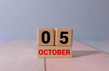 October 5th. Image of October 5 wooden color calendar on white background.