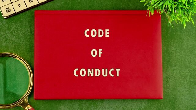 Animation of the CODE OF CONDUCT concept words on a business book with a red cover. Business, Ethics and respect in working collective concept