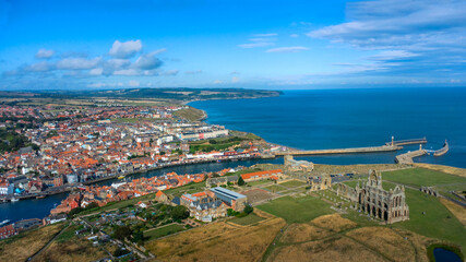 Coastal harbor town with boats and historic stone pier