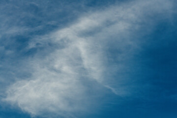 High cloud in the blue afternoon sky