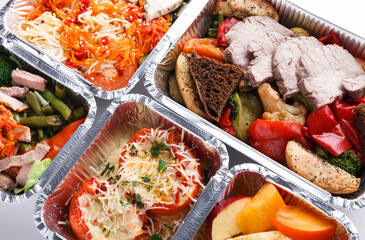 Healthy restaurant food background. Eating right concept. Fresh diet daily meals delivery. Fitness nutrition, vegetables, meat and fruits in foil boxes on wood