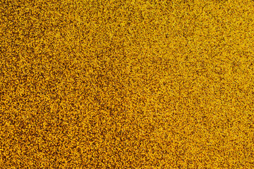 A gold colored background with a lot of small dots