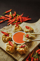 spicy chicken and shrimp dim sum siomay served with chili sauce, food