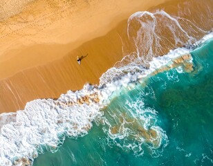 drone aerial of turquoise waves crashing on golden sandy beach with lone surfer