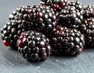 Close-up of blackberries on a dark surface