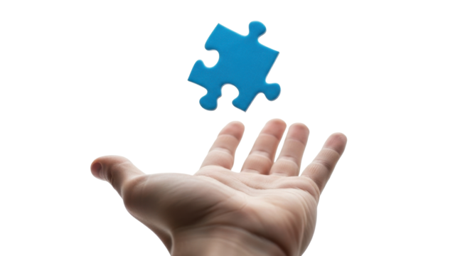 A hand reaches up to catch a floating blue jigsaw puzzle piece against a white background.