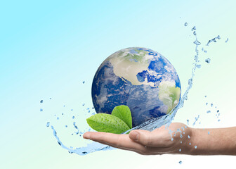 Save water concept. Earth with green leaves and water splashes in man's hand against blue gradient...