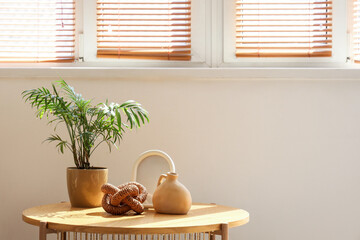 Home decor with houseplant on coffee table near window in living room