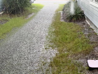 Water from a severe rainstorm floods the yard between two houses