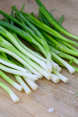 Fresh organic green onions washed and prepared for slicing to use as an ingredient, part of luau dinner preparations 
