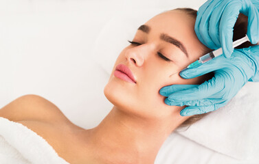 Beauty procedure. Woman receiving hyaluronic acid injection in spa salon