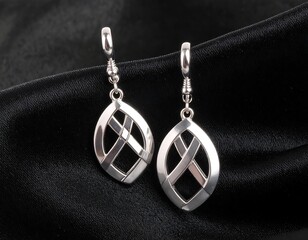 Elegant silver earrings on black fabric