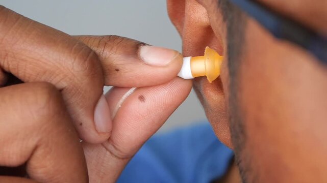 inserting earplugs or earbuds 4k video