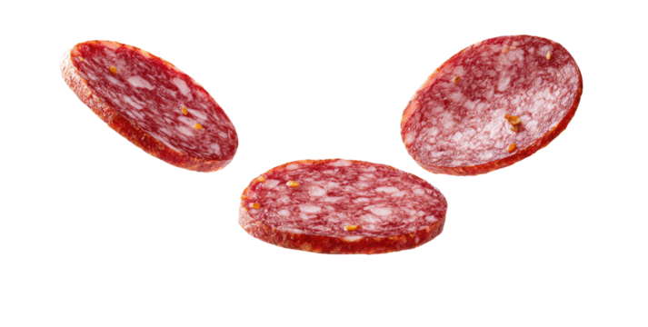 Three slices of salami,  a light reddish-pink color,  with visible flecks of seasoning,  are  floating  in the air, arranged in a  v-shape