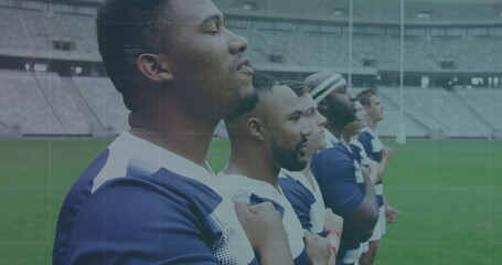 Standing rugby players in jerseys placing right hands over hearts on stadium pitch, with goalposts
