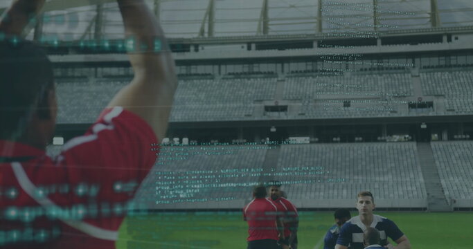 Group of rugby players practicing on grass at empty stadium, holding ball with code overlay