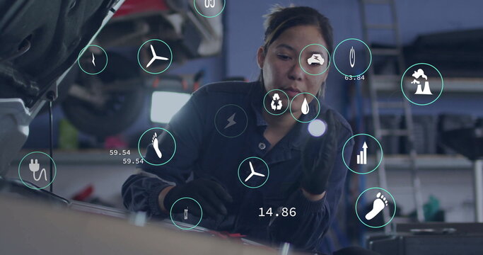 Female mechanic in coveralls and gloves inspecting engine under open hood in garage, with eco icons - Powered by Adobe