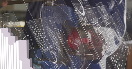 Standing technician wearing denim jacket touching workshop data panels, with wheel and red caliper